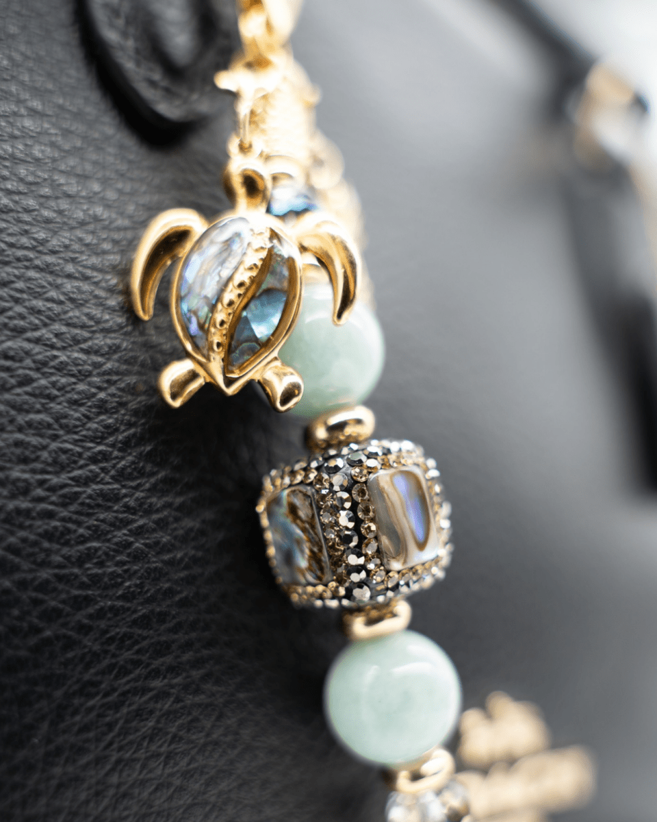 LD Keyfinder Paua Paradise Mini featuring aqua Malaysian jade, paua shell, and gold-plated turtle charm on black leather