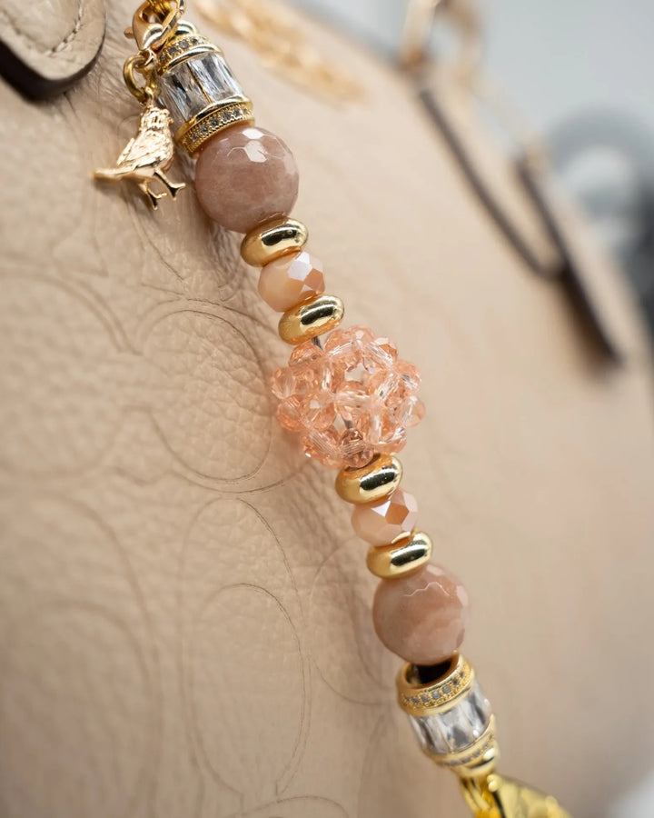 LD Keyfinder Petite Birdsong Bliss featuring peach glass, faceted sunstone beads, and a gold-plated bird charm.