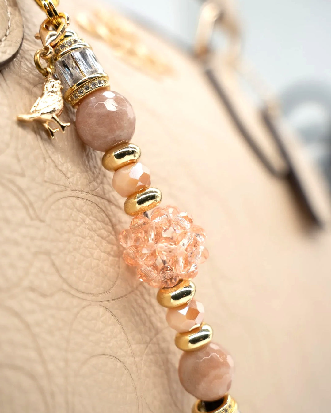 LD Keyfinder Petite Birdsong Bliss featuring peach glass, sunstone beads, and a gold-plated bird charm on a key clip.