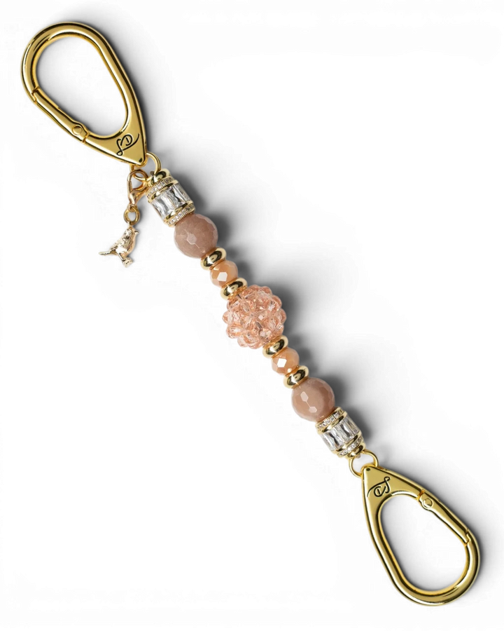 LD Keyfinder Petite Birdsong Bliss featuring peach glass, sunstone beads, and a gold-plated bird charm on a key clip.
