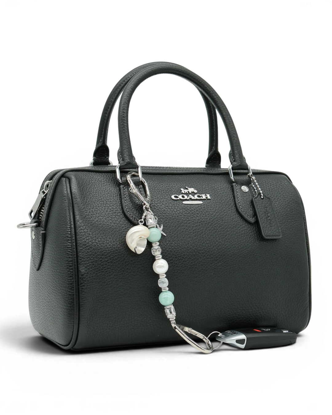 LD Keyfinder Petite Caribbean Pearl beaded charm with shell and starfish accents attached to a black leather handbag.