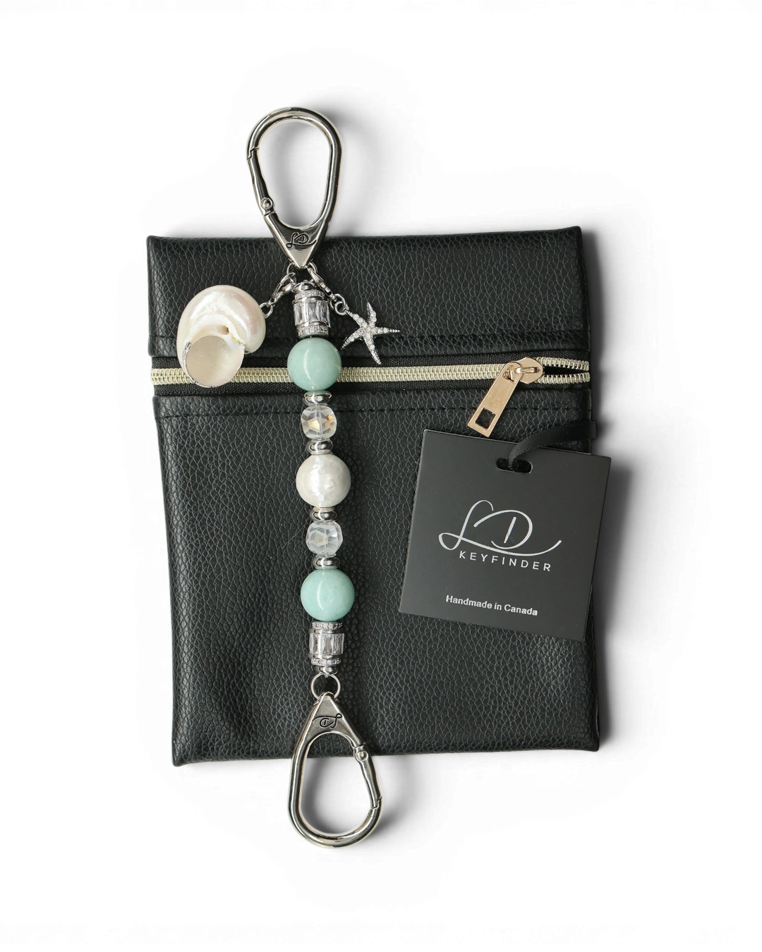 LD Keyfinder Petite Caribbean Pearl keychain with aqua jade, shell pearl, and starfish charm on a black leather bag.