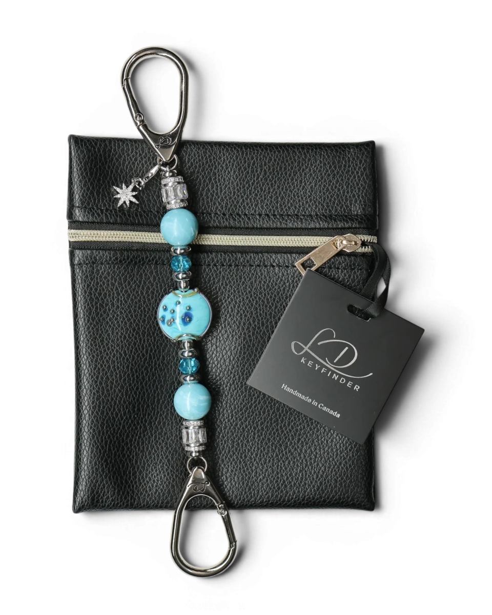 LD Keyfinder Petite Celestial Tide keychain with turquoise glass art bead, larimar, and silver accents, attached to a black pouch.