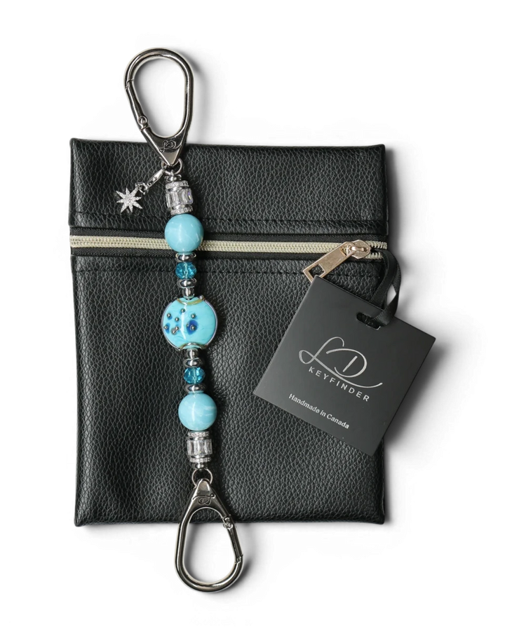 LD Keyfinder Petite Celestial Tide keychain with turquoise glass art bead, larimar, and silver accents, attached to a black pouch.