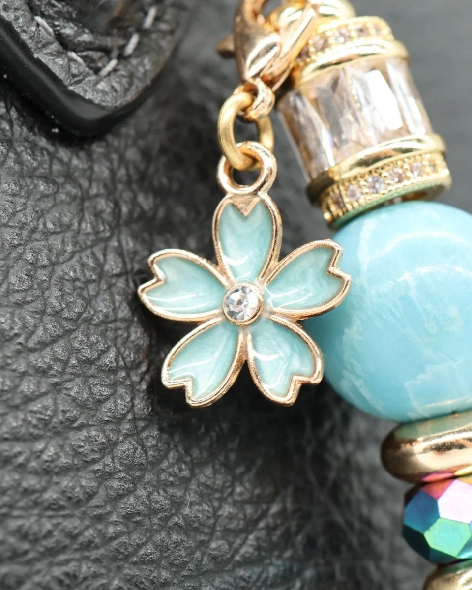 LD Keyfinder Petite Gilded Fantasy charm with blue enamel flower, gold plating, and crystal accents.