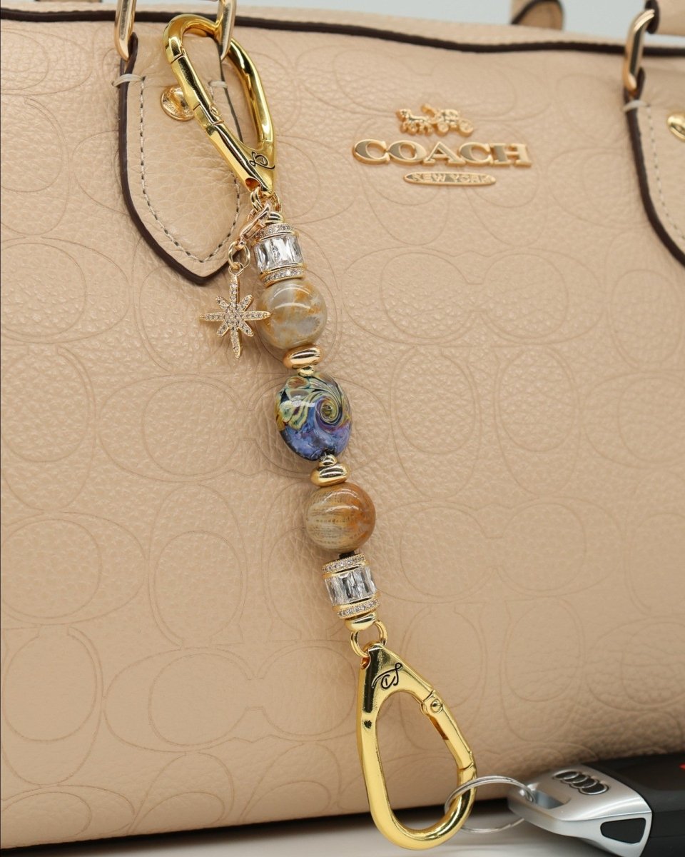 LD Keyfinder Petite Golden Nebula keychain with artisan glass bead, fossil coral, gold-plated spacers, and star charm.