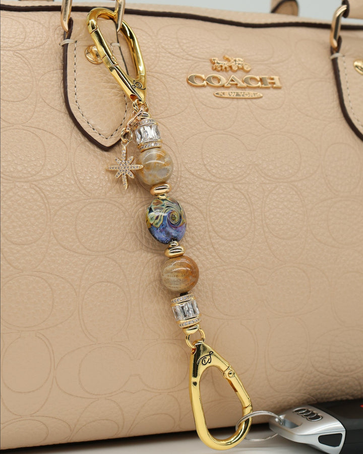 LD Keyfinder Petite Golden Nebula keychain with artisan glass bead, fossil coral, gold-plated spacers, and star charm.