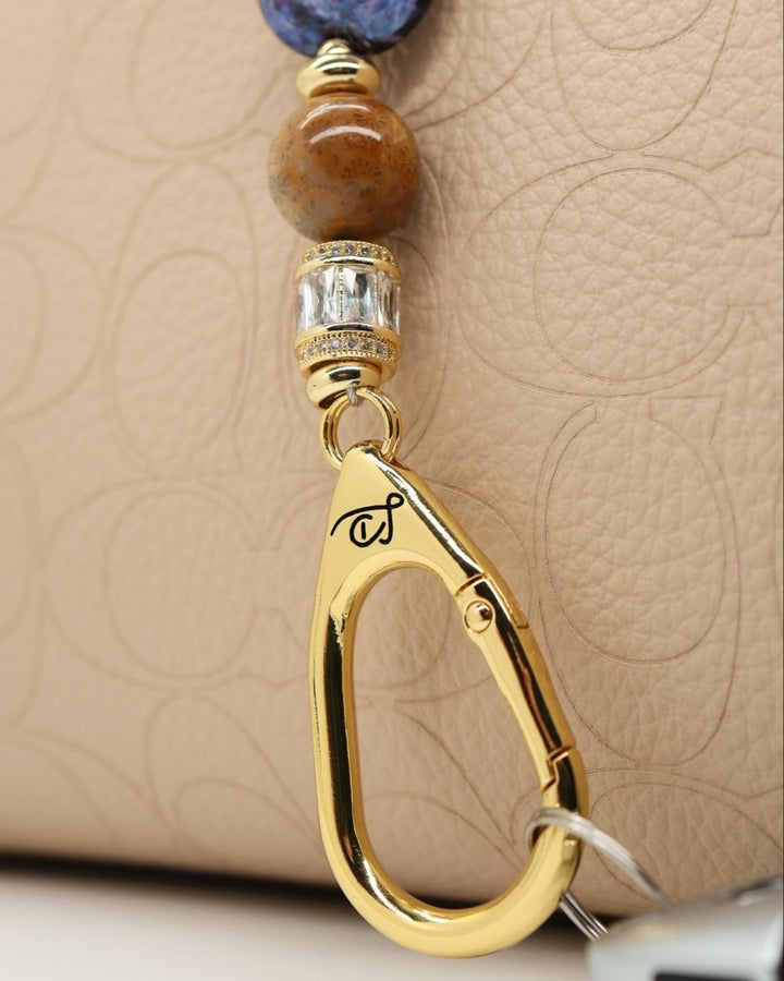 LD Keyfinder Petite Golden Nebula keyfinder with artisan glass bead, fossil coral, rhinestones, and gold-plated star charm.
