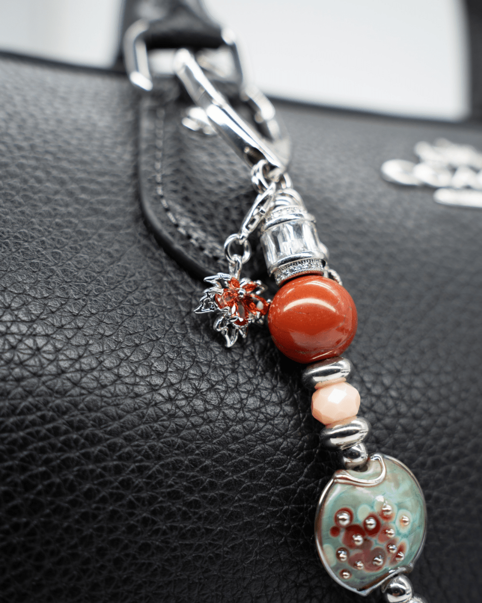 LD Keyfinder Petite Maple Majesty featuring red jasper, peach jade, artisan glass, and autumn-themed charms on a bag.