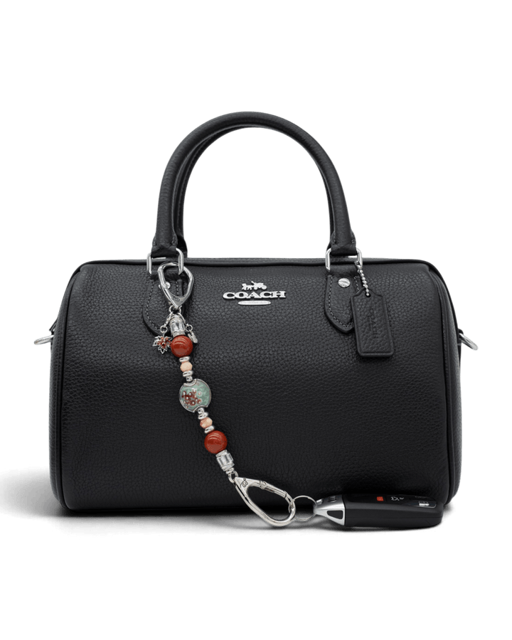 LD Keyfinder Petite Maple Majesty featuring red jasper, peach jade, and artisan glass beads attached to a black handbag.