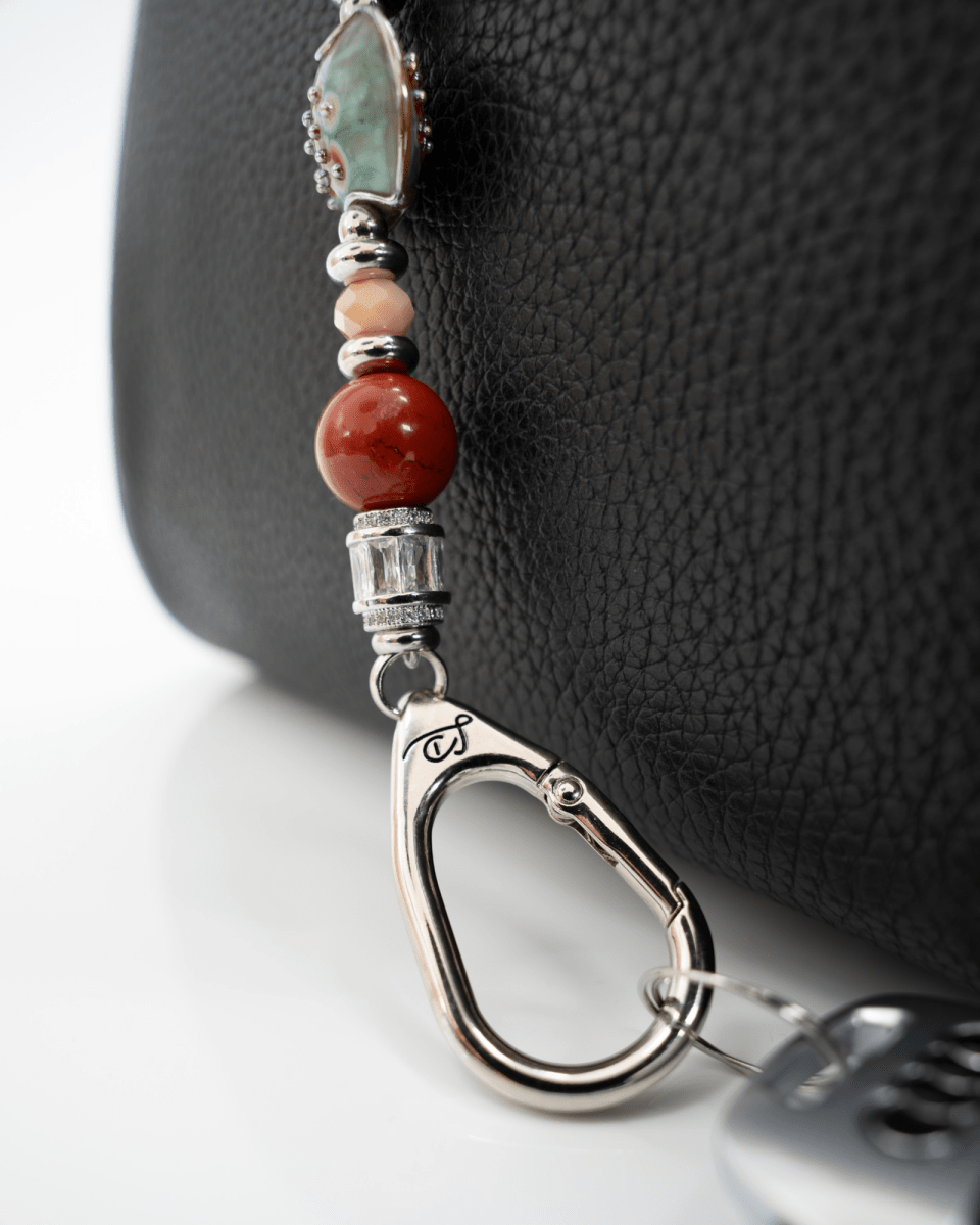 LD Keyfinder Petite Maple Majesty featuring red jasper, peach jade, artisan glass, and a maple leaf charm on a bag.