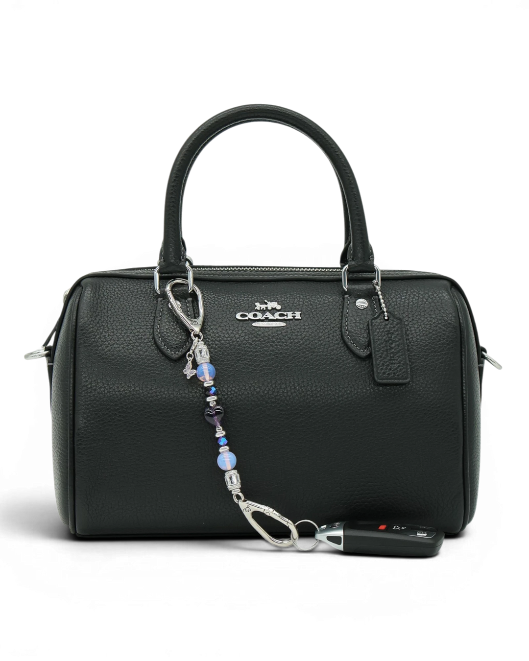 LD Keyfinder Petite Orchid Flutter accessory with pink opalite and purple glass beads attached to a black handbag.