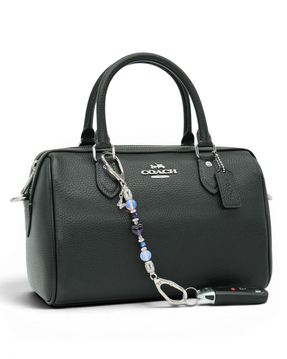LD Keyfinder Petite Orchid Flutter accessory with pink opalite and purple glass beads attached to a black handbag.