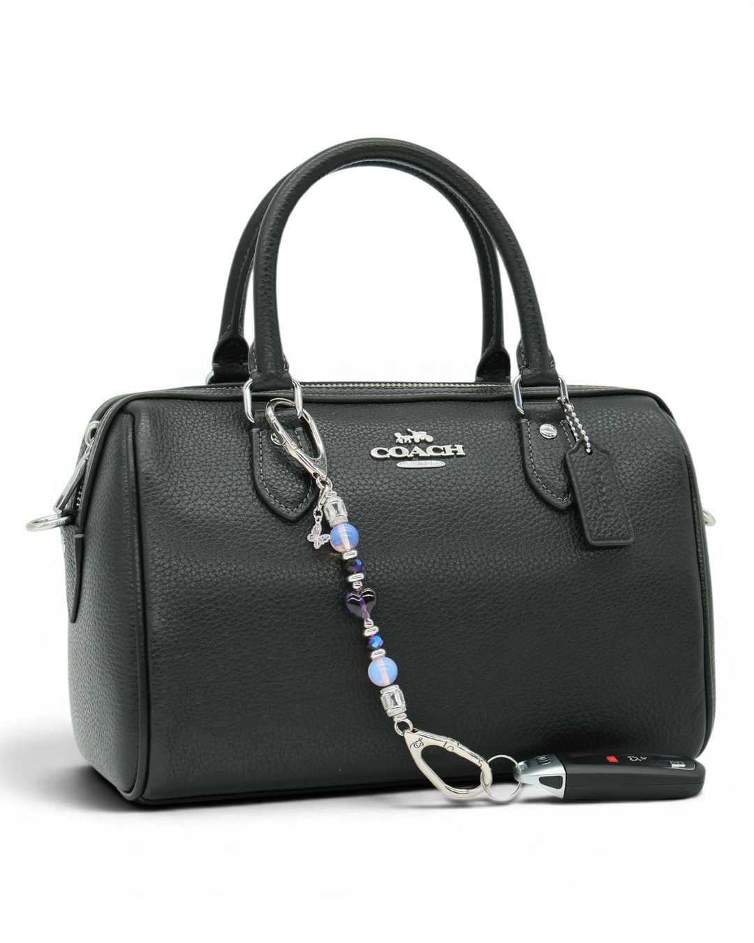 LD Keyfinder Petite Orchid Flutter accessory with pink opalite and purple glass beads attached to a black handbag.