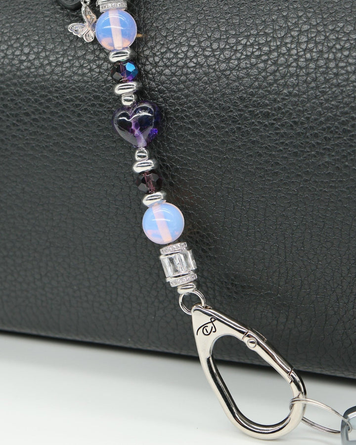 LD Keyfinder Petite Orchid Flutter with pink opalite, dark orchid glass beads, and a rhinestone butterfly charm.