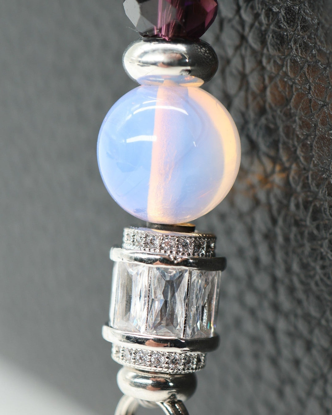 LD Keyfinder Petite Orchid Flutter featuring pink opalite, faceted dark orchid glass, and platinum-plated accents.