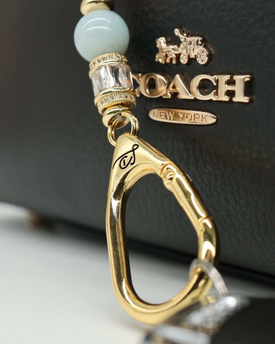 LD Keyfinder Petite Pastel Garden charm bracelet with aquamarine, pink glass beads, and gold-plated details.