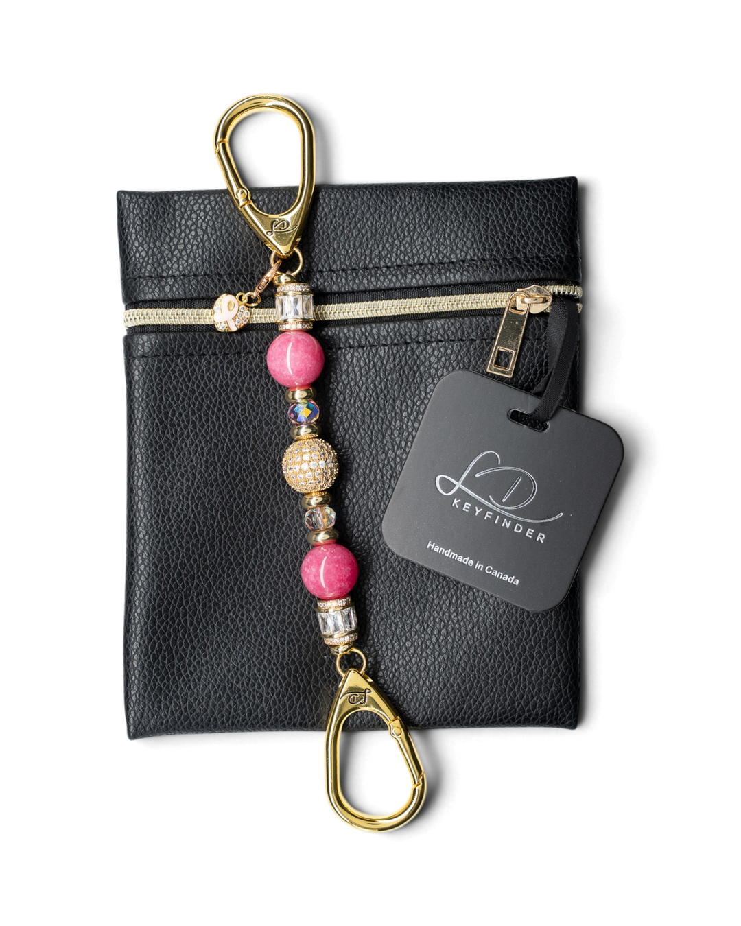LD Keyfinder Petite Radiant Hope beaded keychain with pink jade, gold pavé, and ribbon charm on a black leather pouch.