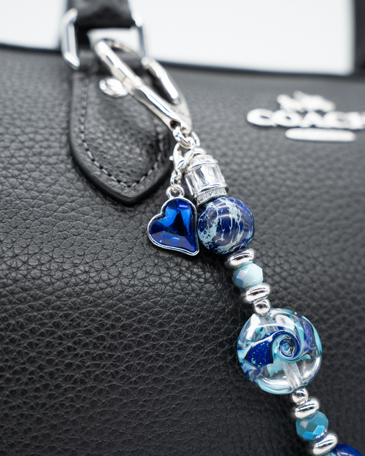 LD Keyfinder Petite Sapphire Allure featuring blue artisan glass, jasper beads, and a sapphire heart charm on a bag.