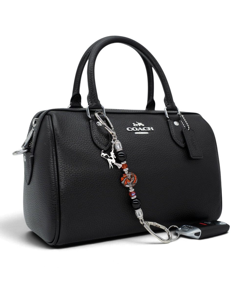 LD Keyfinder Petite Spellbound Halloween charm featuring obsidian, orange glass, and a witch on a broom on a black bag.