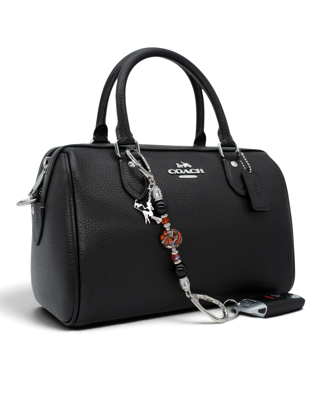 LD Keyfinder Petite Spellbound Halloween charm featuring obsidian, orange glass, and a witch on a broom on a black bag.