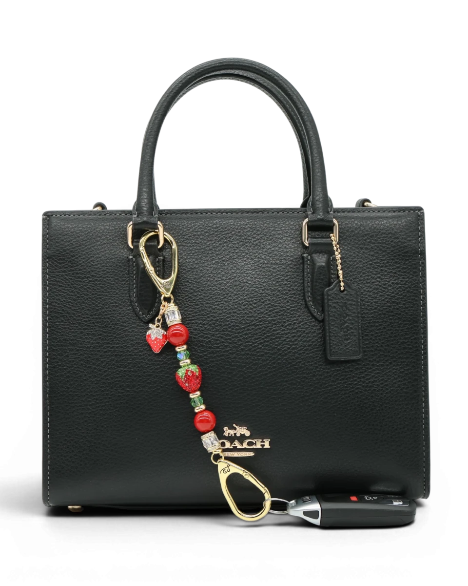 LD Keyfinder Petite Strawberry Fields accessory with red shell pearls, crystal strawberry, and gold-plated charm.