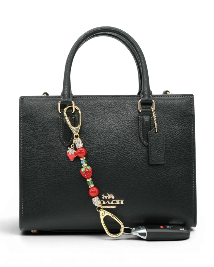 LD Keyfinder Petite Strawberry Fields accessory with red shell pearls, crystal strawberry, and gold-plated charm.