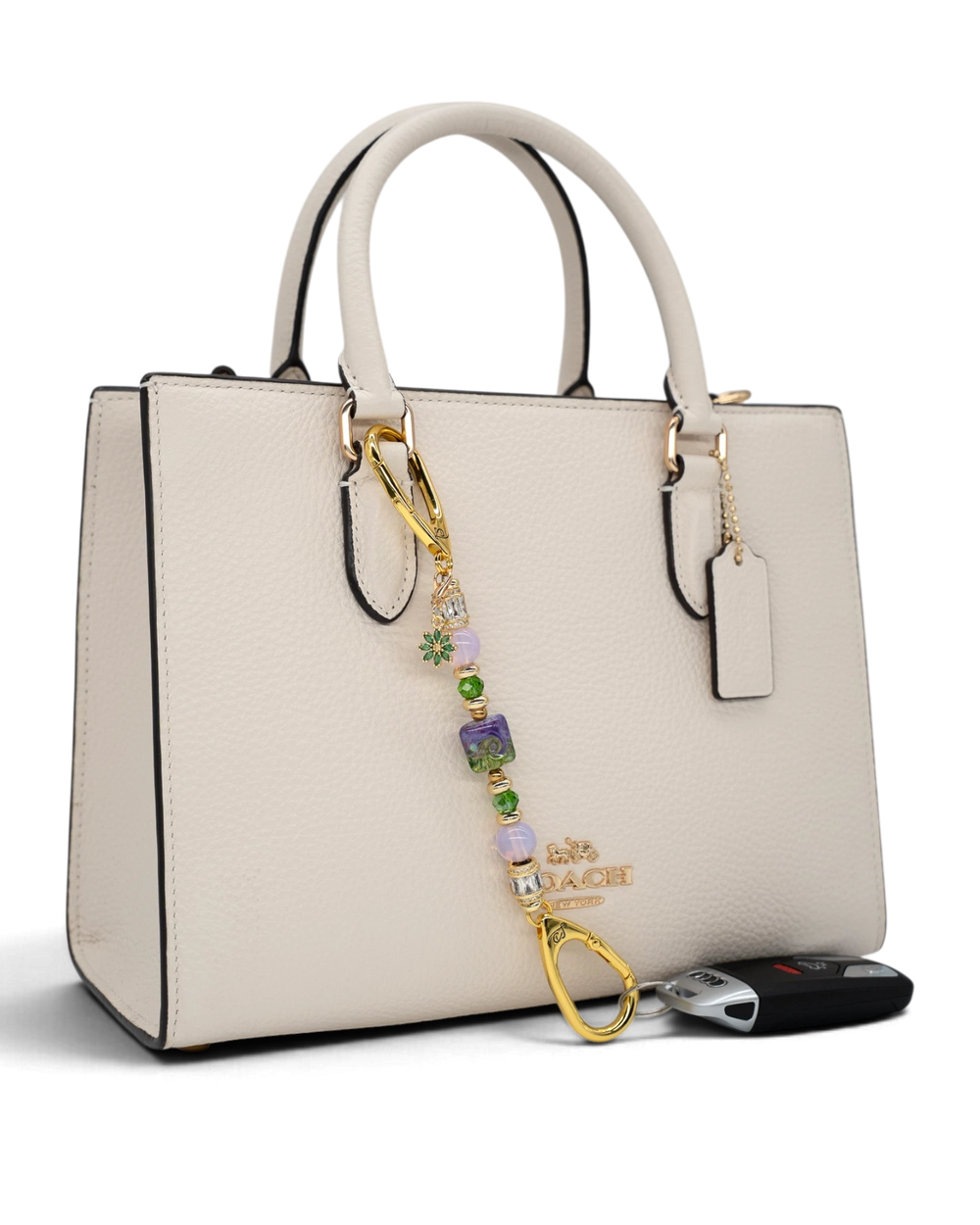 LD Keyfinder Petite Verdant Bloom accessory featuring lampwork glass, pink opalite, and gold-plated flower charm on bag