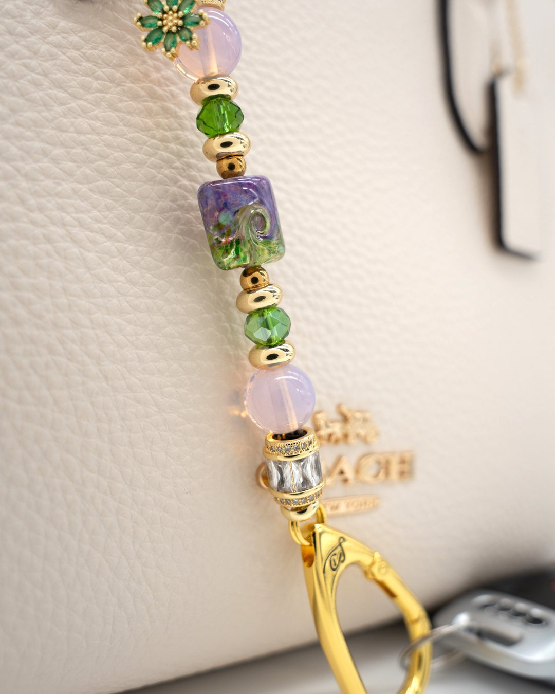 LD Keyfinder Petite Verdant Bloom featuring artisan lampwork glass, pink opalite, green crystals, and gold-plated charm.