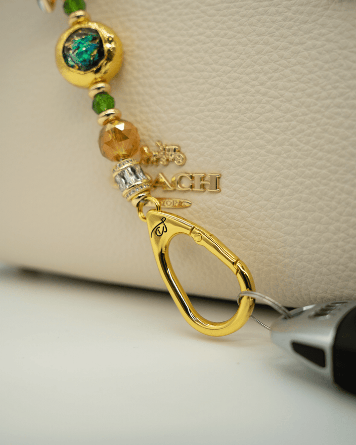 LD Keyfinder Petite Verdant Flame featuring orange and green glass beads, gold-plated accents, and a leaf charm.