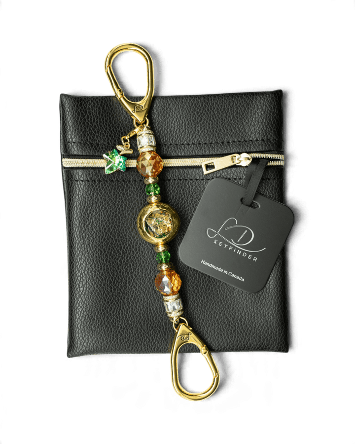 LD Keyfinder Petite Verdant Flame beaded accessory with orange and green glass beads, gold accents, and a leaf charm.
