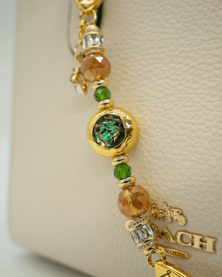 LD Keyfinder Petite Verdant Flame featuring orange and green glass beads with a gold-plated resin centerpiece