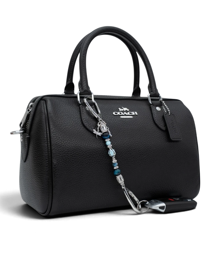 LD Keyfinder Petite Whispering Garden accessory featuring a blue glass tulip, tiger eye beads, and charms on a handbag