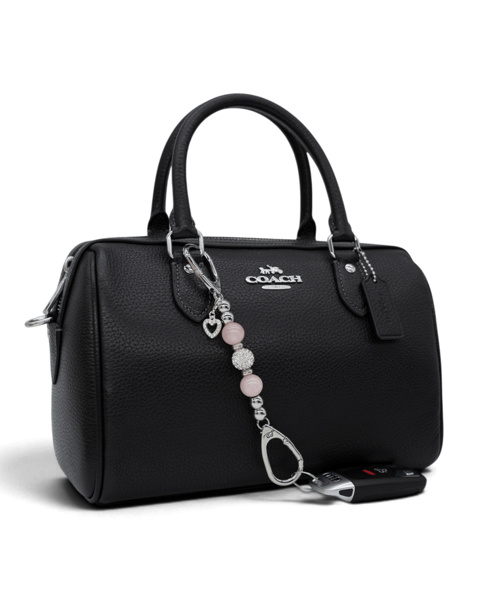 LD Keyfinder Princess Pink-Mini rose quartz and rhinestone charm attached to a black leather handbag with a car key.