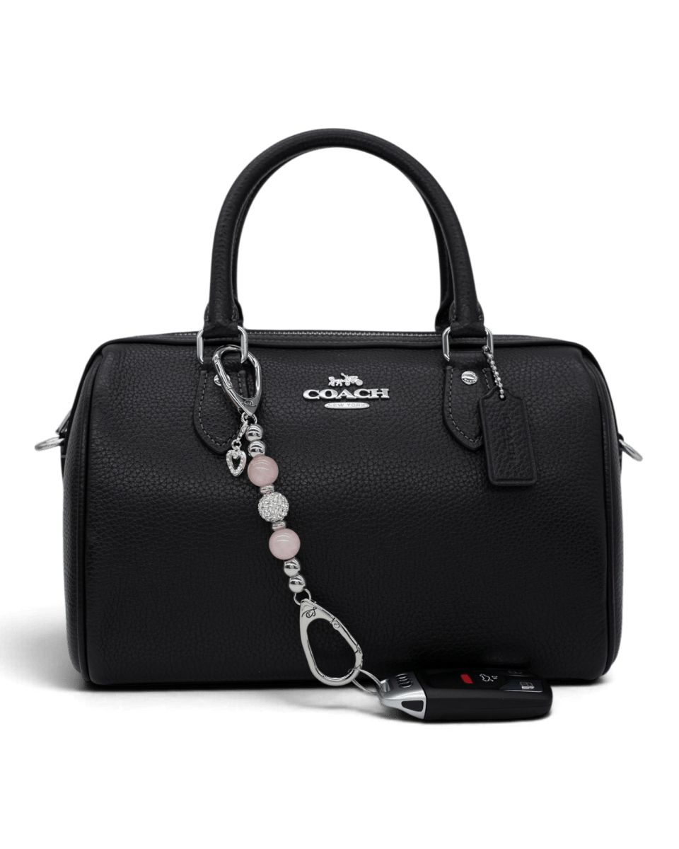 LD Keyfinder Princess Pink-Mini rose quartz beaded keychain with heart charm attached to a black leather handbag.