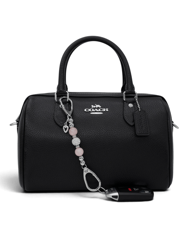 LD Keyfinder Princess Pink-Mini rose quartz beaded keychain with heart charm attached to a black leather handbag.