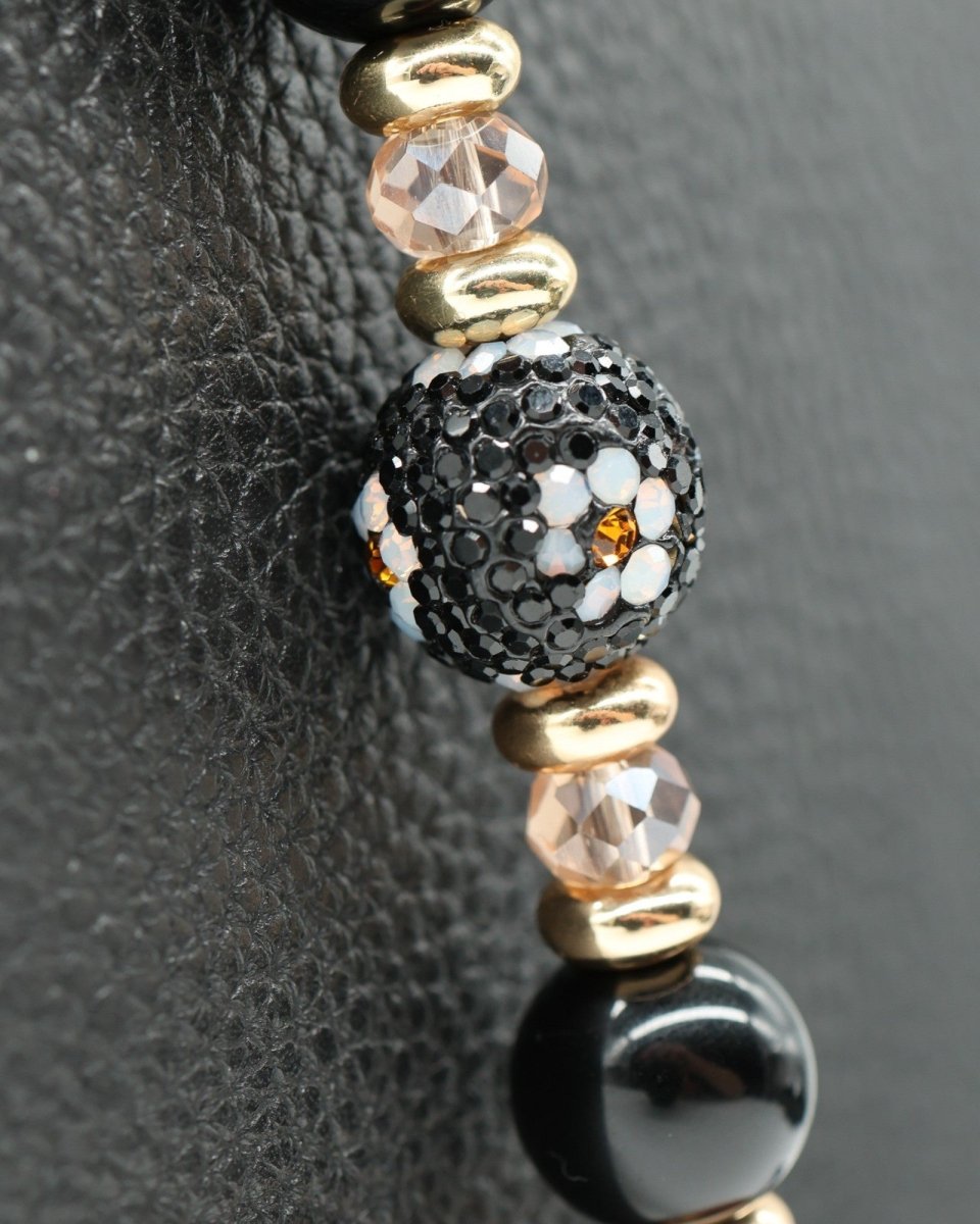 LD Keyfinder Queen Bee II bracelet with black obsidian, gold, and crystal daisy beads.