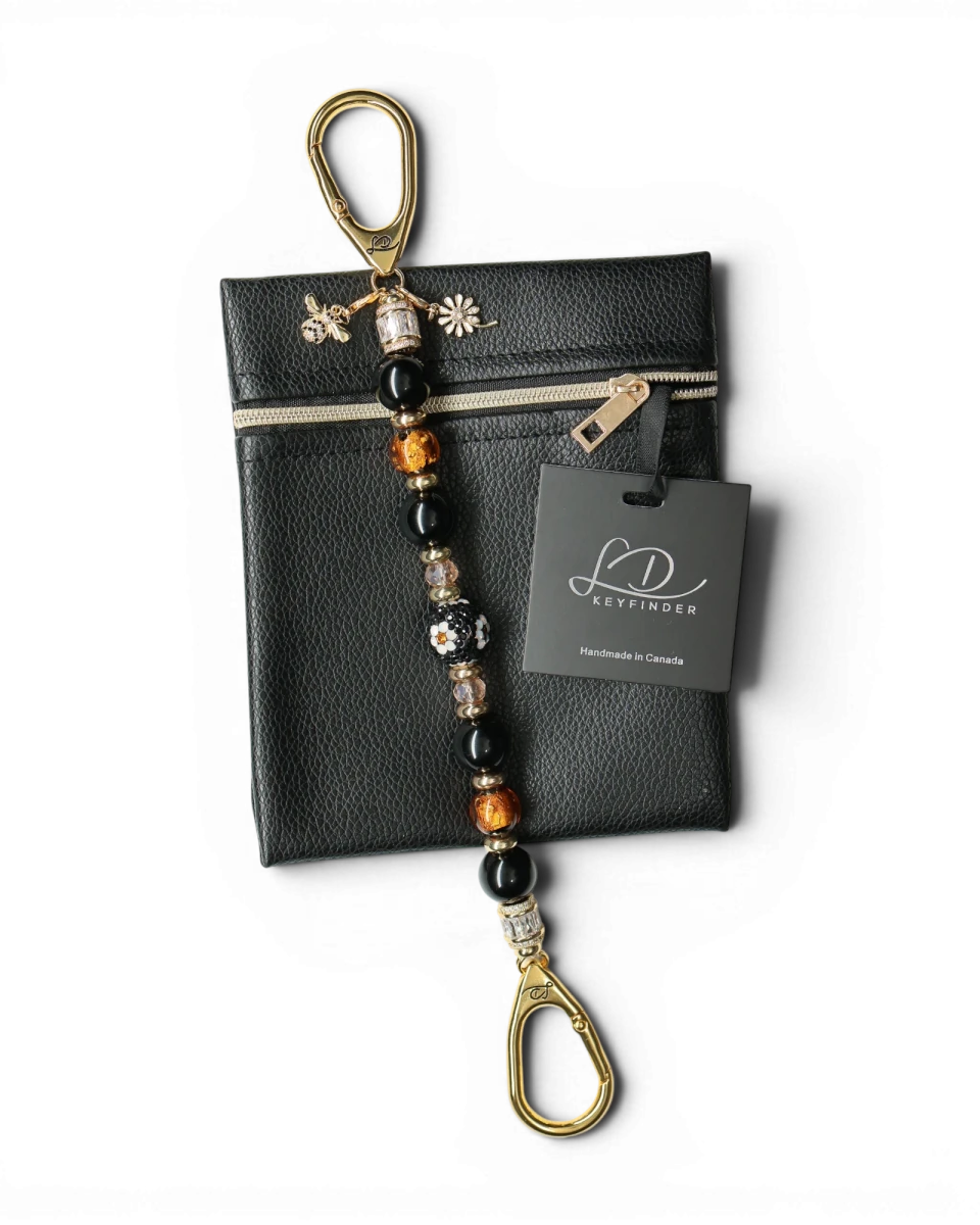 LD Keyfinder Queen Bee II keychain with black obsidian, gold, and crystal beads, featuring a bee charm and daisy charm.