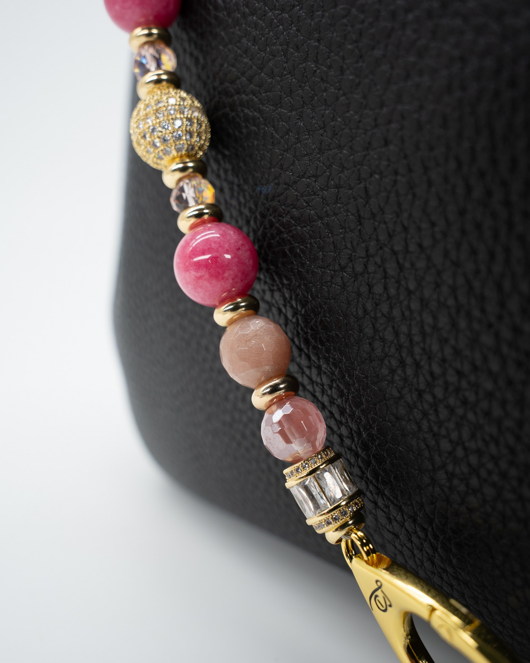 LD Keyfinder Radiant Hope beaded keychain with pink gemstones, gold-plated accents, and a pavé rhinestone centerpiece.