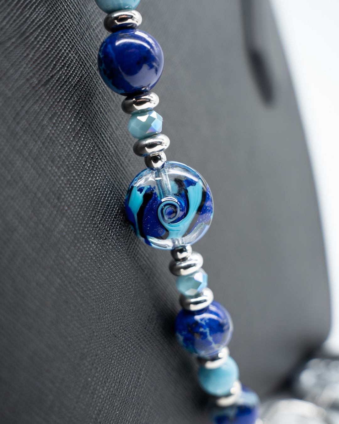 LD Keyfinder Sapphire Allure beaded accessory featuring a handcrafted blue swirling glass bead, Blue Jasper, and Larimar.