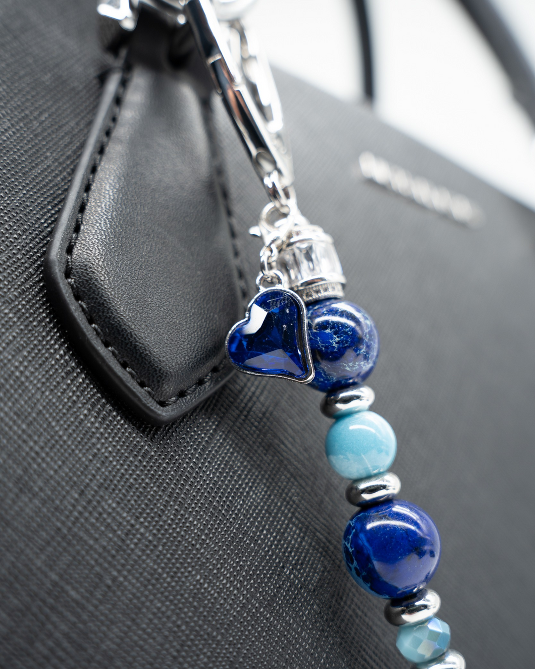 LD Keyfinder Sapphire Allure featuring blue jasper, larimar, and glass beads with a sapphire heart charm on a bag.