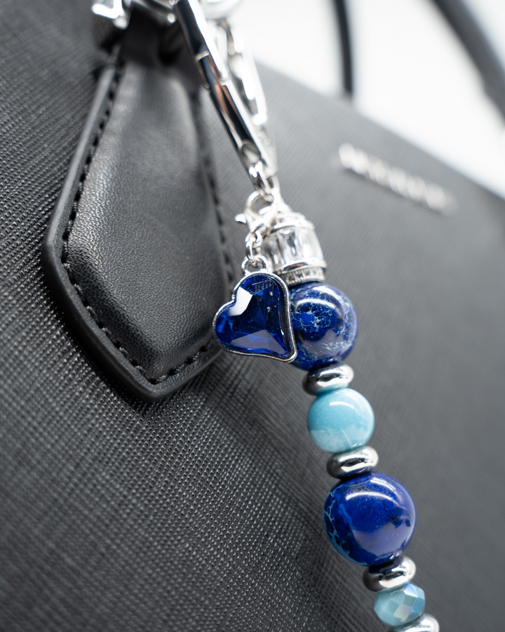LD Keyfinder Sapphire Allure featuring blue jasper, larimar, and glass beads with a sapphire heart charm on a bag.