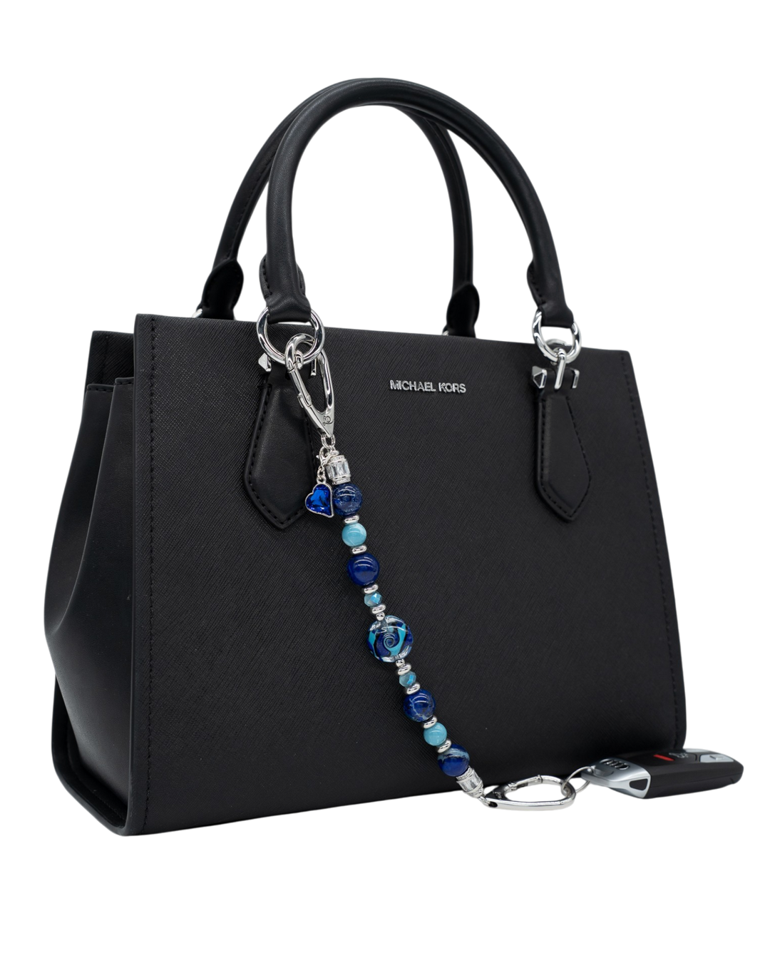 LD Keyfinder Sapphire Allure beaded accessory with blue jasper, larimar, and glass beads attached to a black handbag.