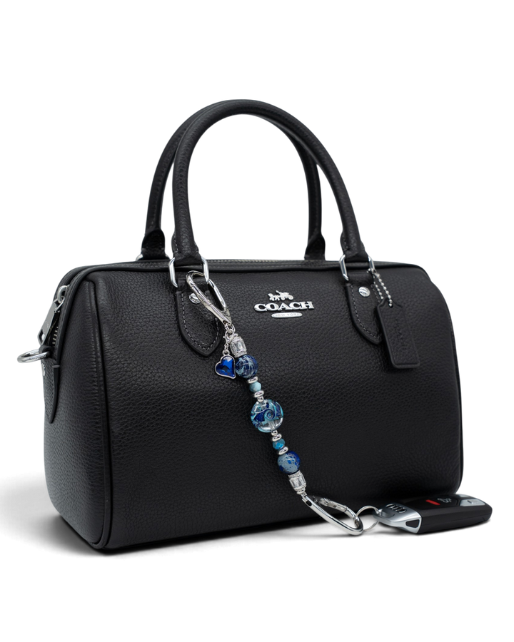 LD Keyfinder Petite Sapphire Allure featuring blue artisan glass, jasper, and jade beads attached to a black handbag.