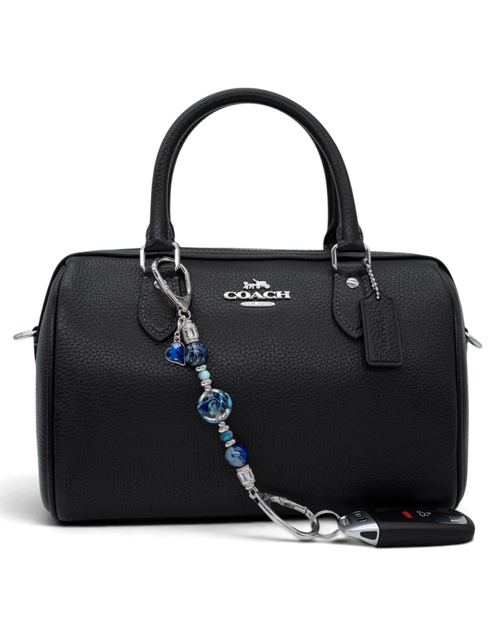 LD Keyfinder Petite Sapphire Allure featuring blue artisan glass, jasper, and jade beads attached to a black handbag.