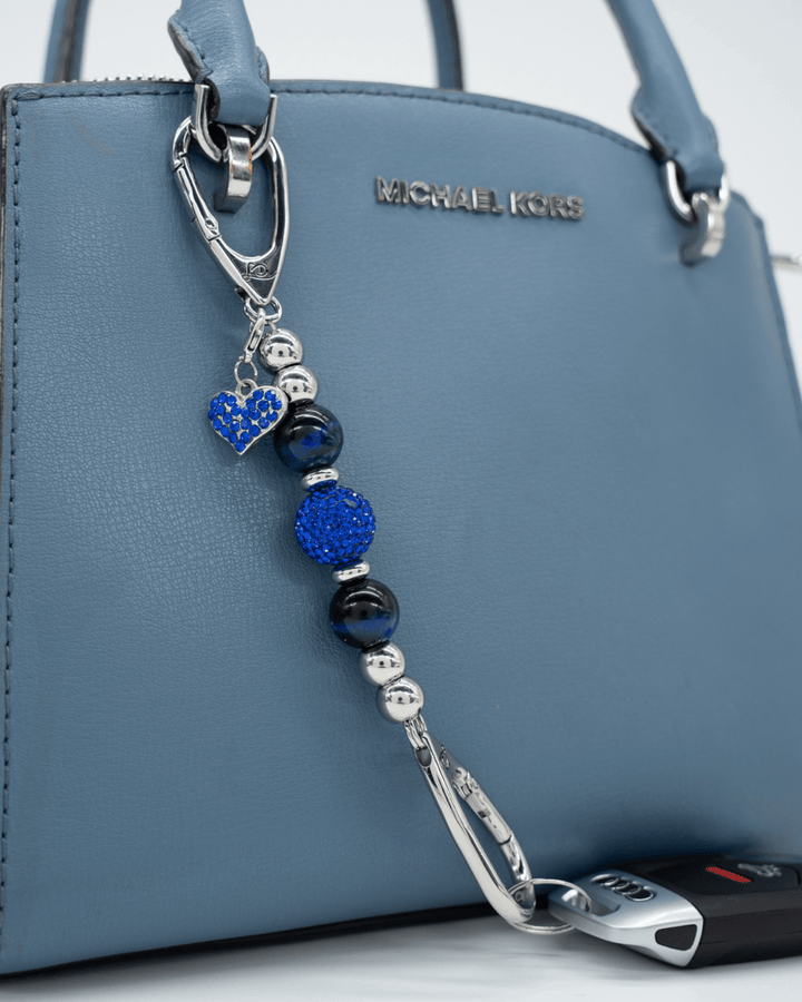 LD Keyfinder Sapphire Shimmer-Mini featuring blue tiger eye beads, Austrian crystals, and a blue heart charm on a bag