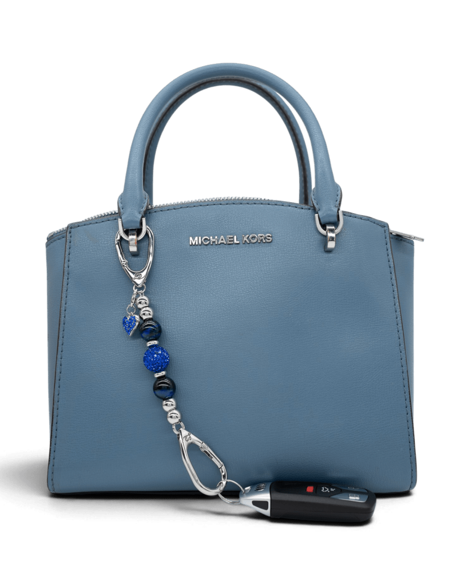 LD Keyfinder Sapphire Shimmer-Mini charm with blue tiger eye beads and heart charm attached to a blue handbag