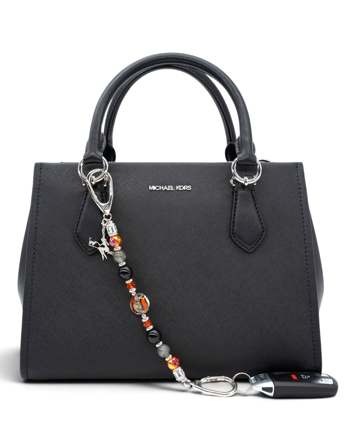 LD Keyfinder Spellbound Halloween accessory with obsidian, moonstone, and orange glass beads attached to a black bag.