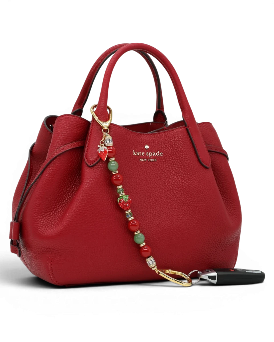 LD Keyfinder Strawberry Fields beaded accessory with red shell pearls, green aventurine, and crystal strawberry charm.