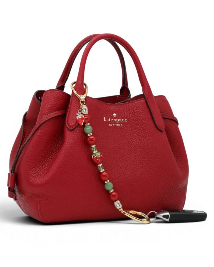 LD Keyfinder Strawberry Fields beaded accessory with red shell pearls, green aventurine, and crystal strawberry charm.